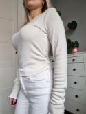 Cream blouse with ruffle on the side