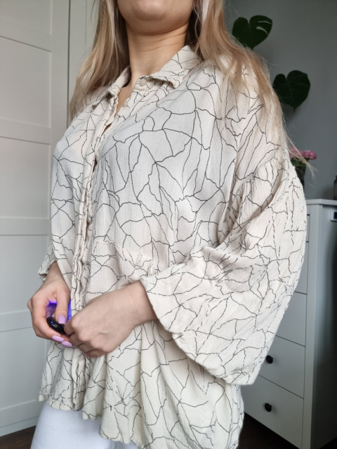 Beige shirt with a ruffle with patterns, size L Beige shirt with a ruffle with patterns, size L