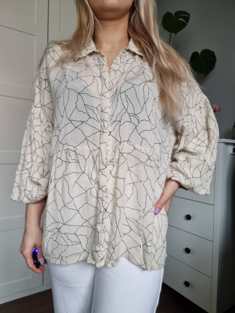 Beige shirt with a ruffle with patterns, size L Beige shirt with a ruffle with patterns, size L