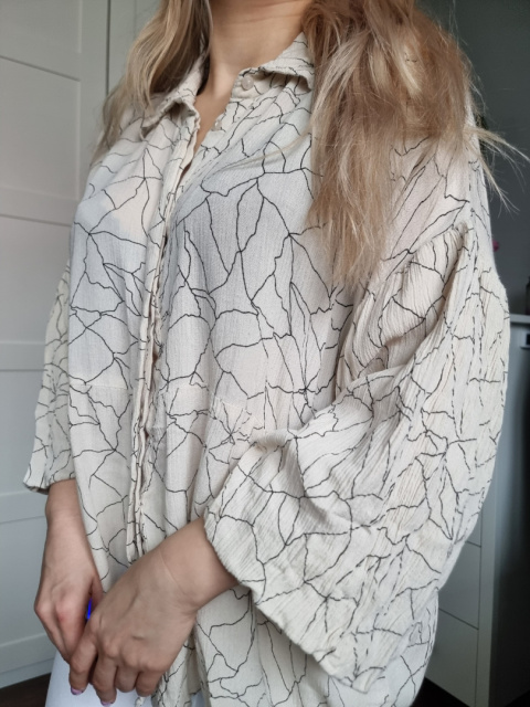 Beige shirt with a ruffle with patterns, size L Beige shirt with a ruffle with patterns, size L